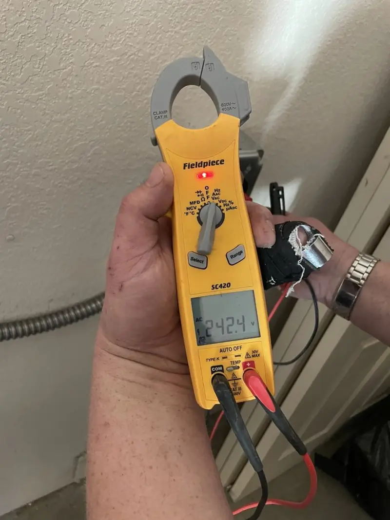 Voltage testing with clamp meter during Outlet Installation in Chaska